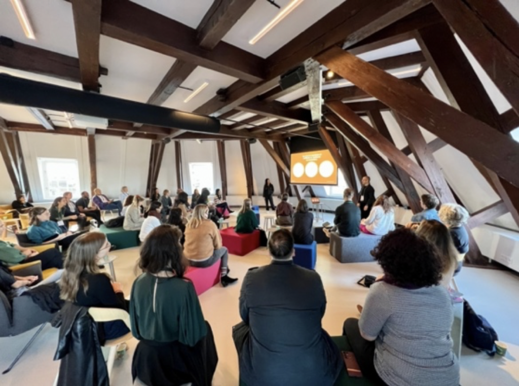 Photo of EPIC2022 attendees watching a presentation by Chelsea Coe and Jonathan DeFaveri