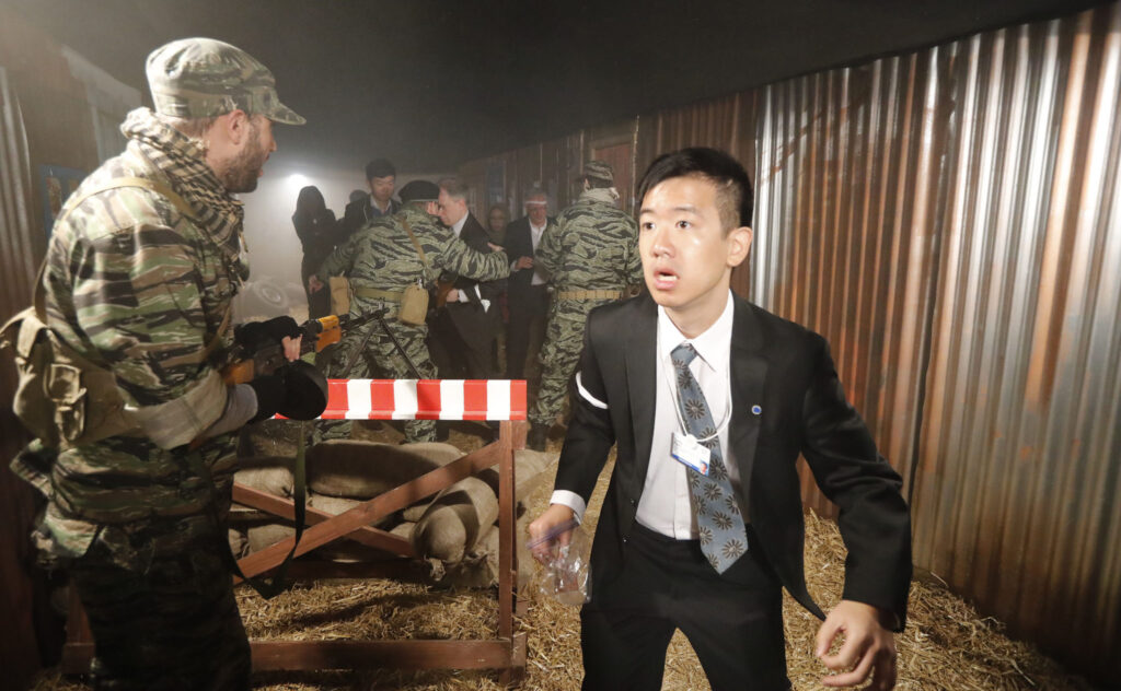 Soldiers check papers and take valuables at the checkpoint at A Day in the Life of a Refugee.