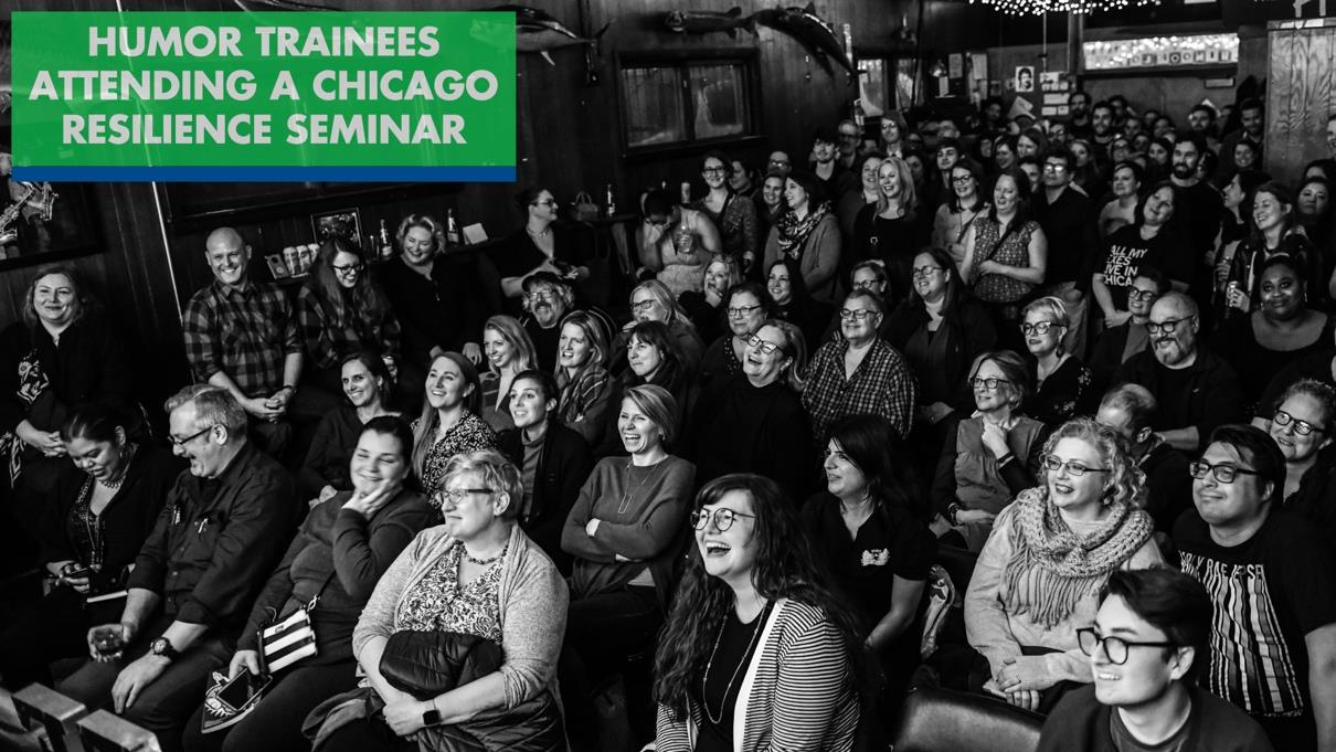 A black and white photo of an audience laughing in a sold-out Chicago club