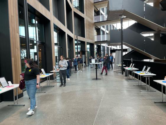 Visitors looking at projects in the “Spoiler Alert” exhibit.