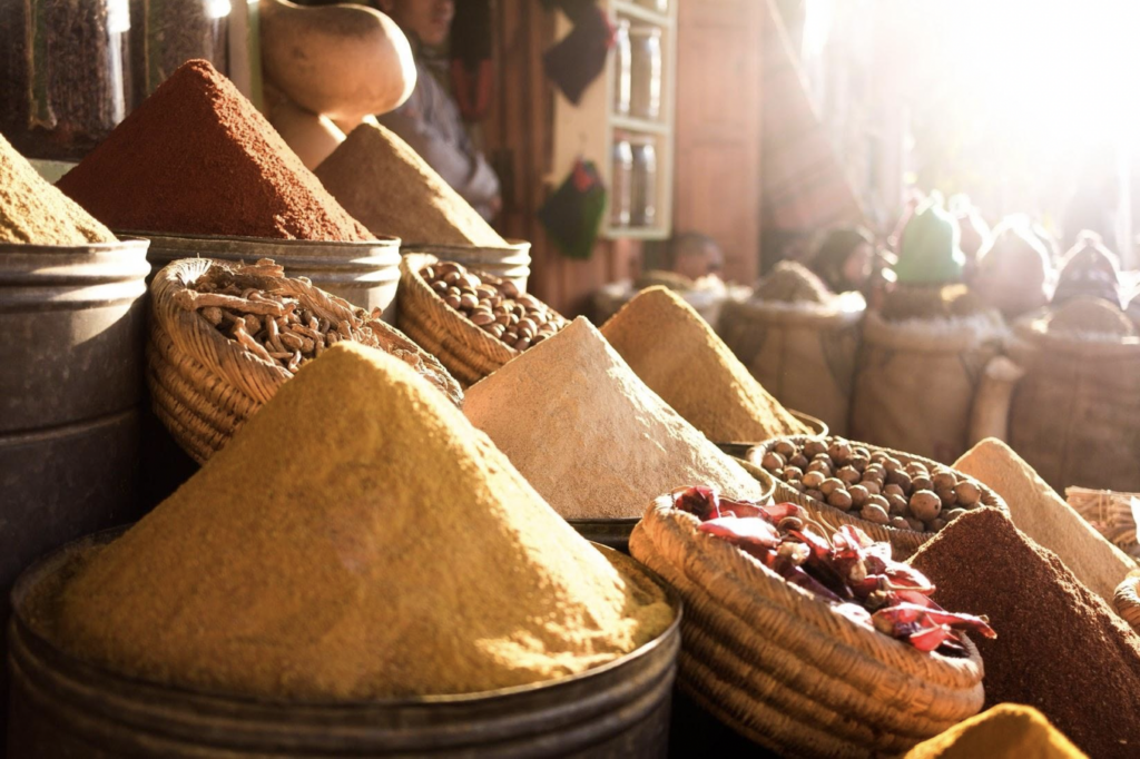 photo of ground spices in baskets and metal containers